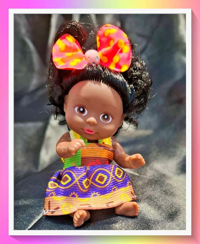 Adorable little pocket size curly hair doll