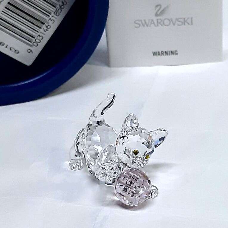 Swarovski Crystal Kitten is playing with a pink ball of wool