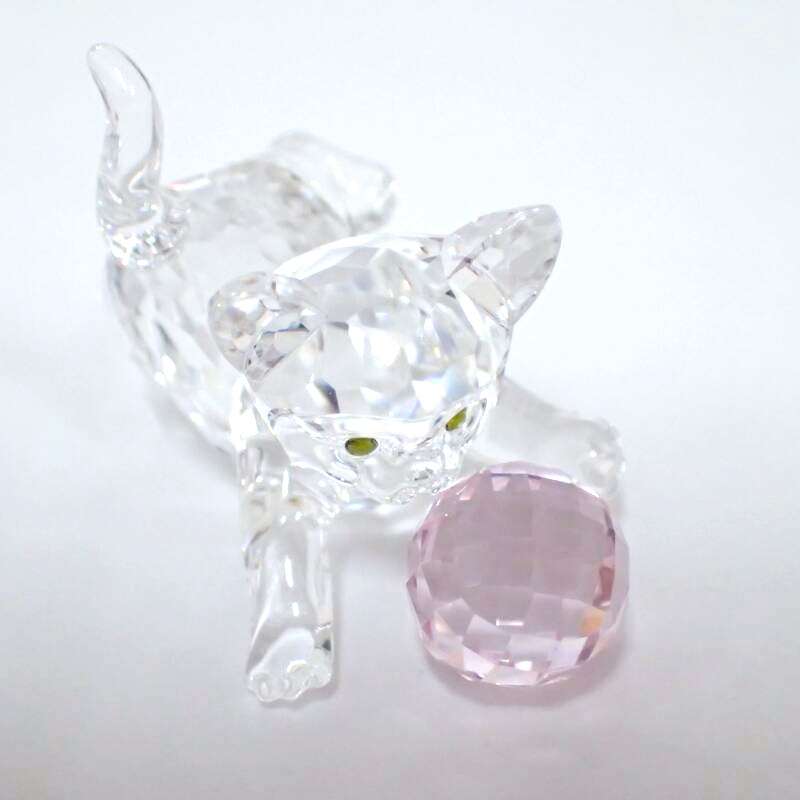 Swarovski Crystal Kitten is playing with a pink ball of wool