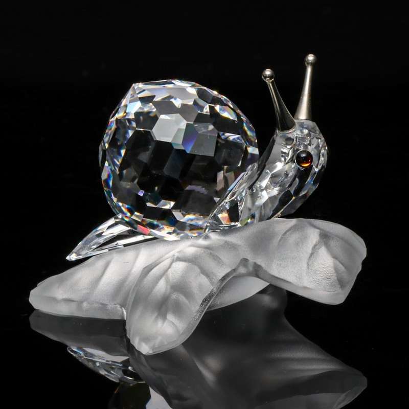 Swarovski Crystal Snail On A Vine Leaf Among Flowers and Foliage