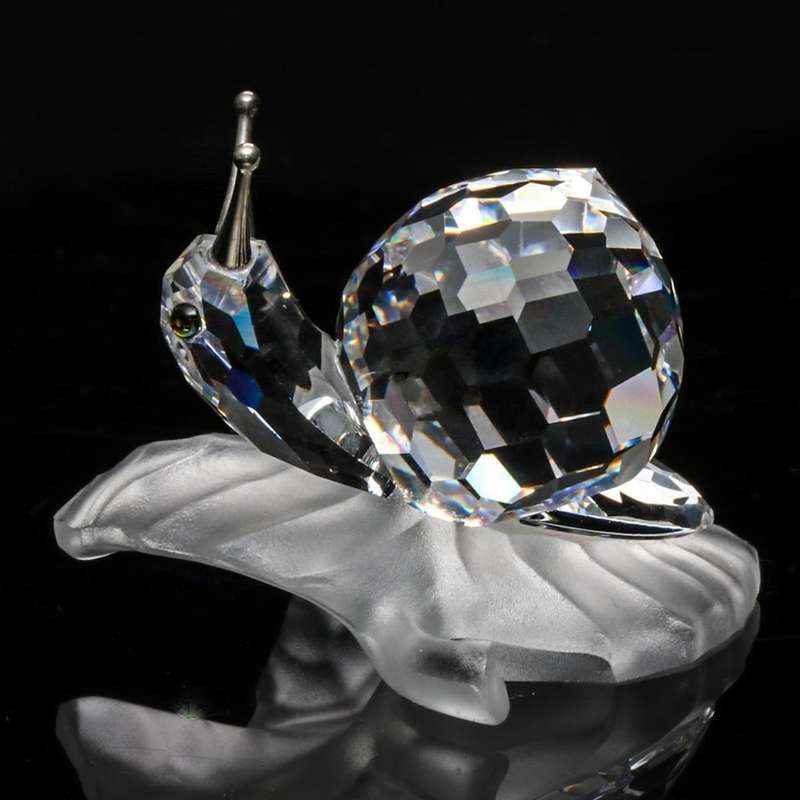 Swarovski Crystal Snail On A Vine Leaf Among Flowers and Foliage