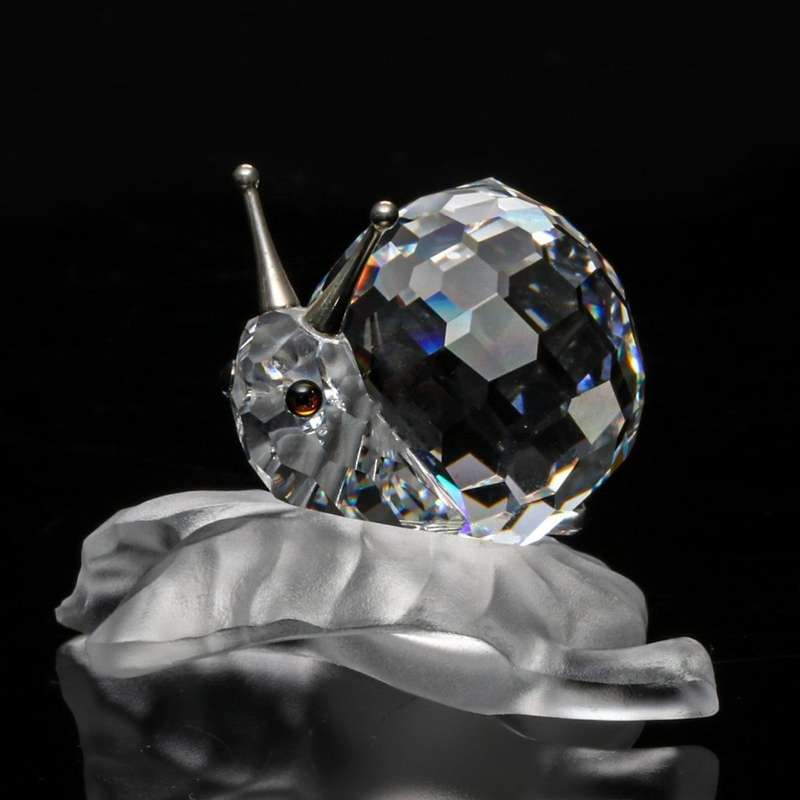 Swarovski Crystal Snail On A Vine Leaf Among Flowers and Foliage