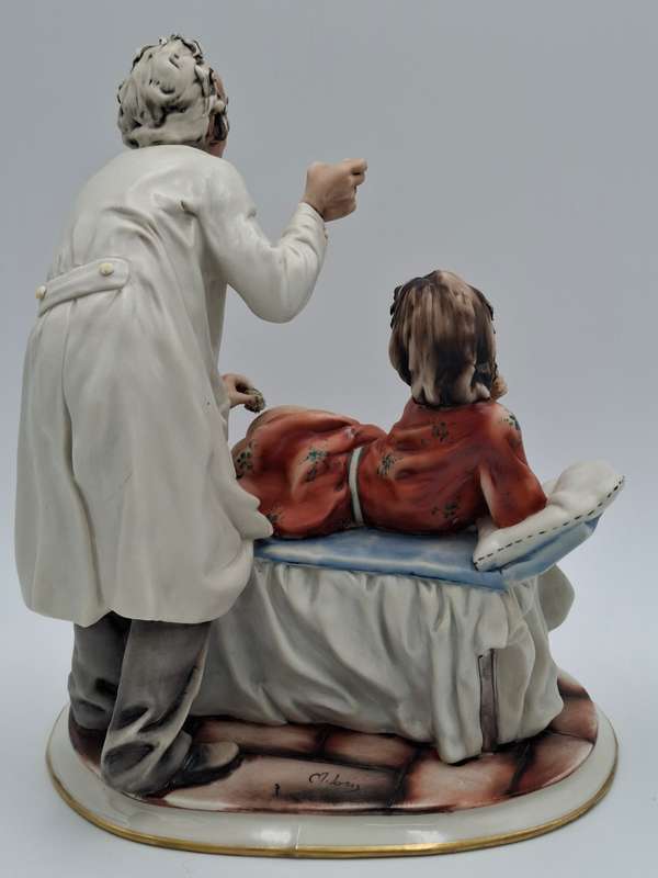 Captivating Italian Risque Capodimonte Sculpture - Doctor treating a Young Woman - Signed by Artist