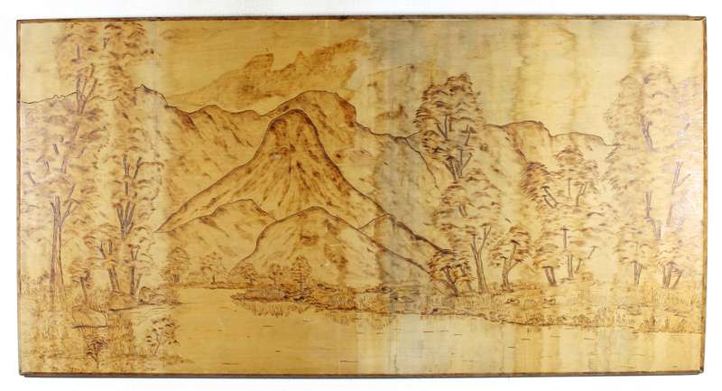 Incised wood panel of a landscape