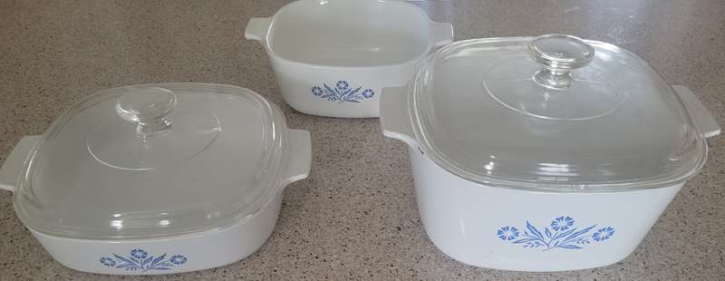 CORNINGWARE CORNFLOWER FROM THE 1960'S TO THE 1990'S-THREE OVENWARE DISHES, TWO WITH LIDS.