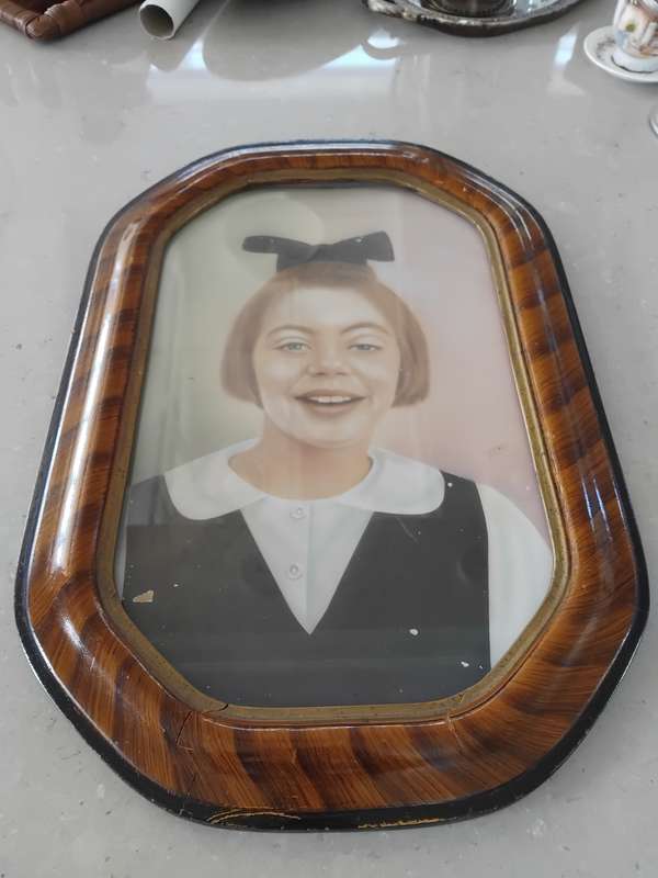 Antique octagon tiger stripe wooden frame with a photo of a little girl
