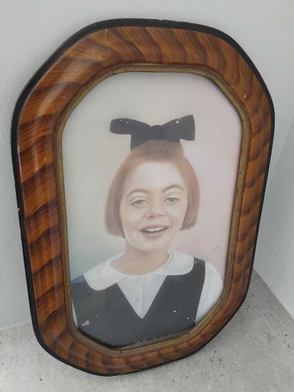 Antique octagon tiger stripe wooden frame with a photo of a little girl