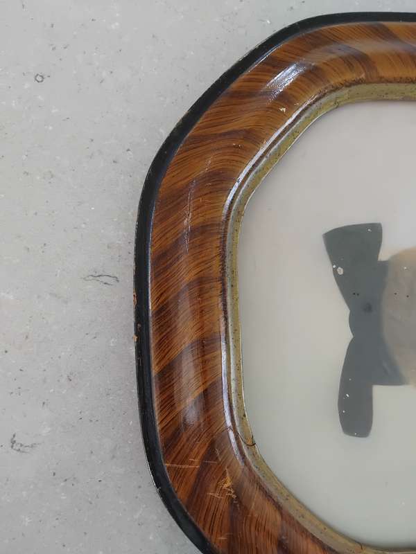 Antique octagon tiger stripe wooden frame with a photo of a little girl