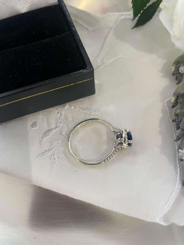 Sterling silver 925 ring featuring a blue gemstone, set in a 925 silver band with cubic zirconia's.