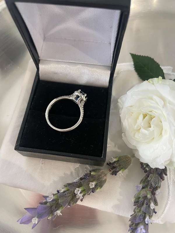 Sterling silver 925 ring featuring a blue gemstone, set in a 925 silver band with cubic zirconia's.