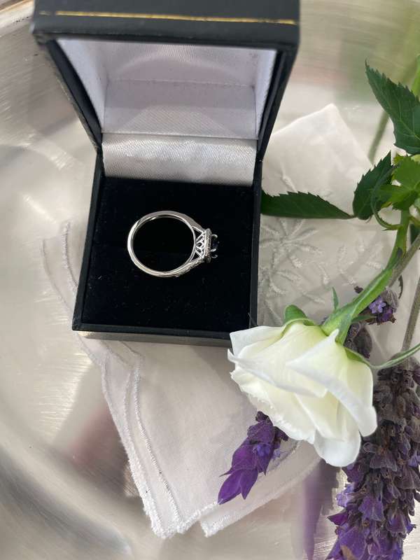 Sterling silver 925 ring featuring a blue gemstone, set in a 925 silver band with cubic zirconia's.