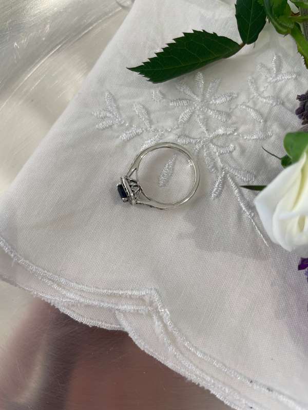 Sterling silver 925 ring featuring a blue gemstone, set in a 925 silver band with cubic zirconia's.