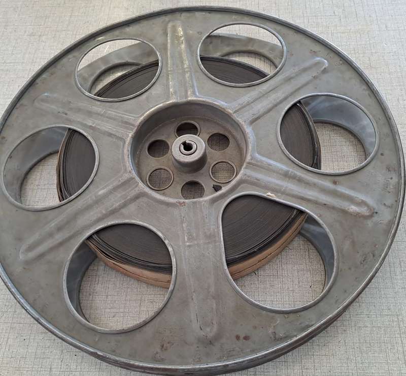 Vintage film reel with African Consolidated Films tag. See description.