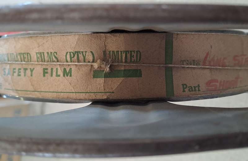 Vintage film reel with African Consolidated Films tag. See description.
