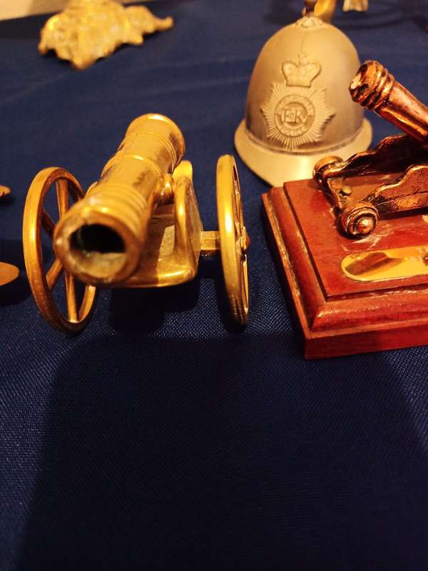 Vintage Brass Cannon Brass Aeroplane. A Cannon and Helmet