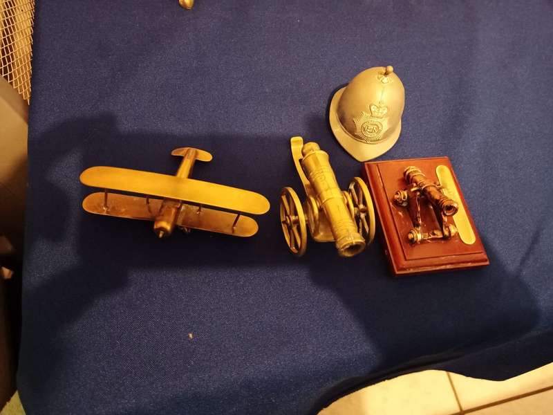 Vintage Brass Cannon Brass Aeroplane. A Cannon and Helmet