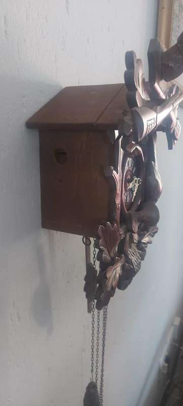 German Black Forest Carved Cuckoo Clock the clock is working but missing one Bird