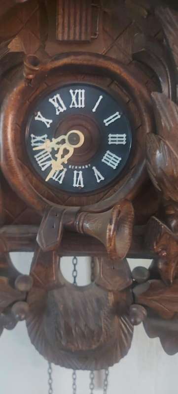 German Black Forest Carved Cuckoo Clock the clock is working but missing one Bird