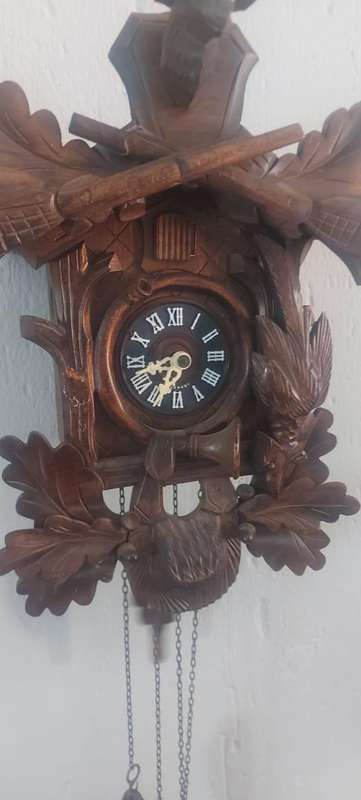 German Black Forest Carved Cuckoo Clock the clock is working but missing one Bird