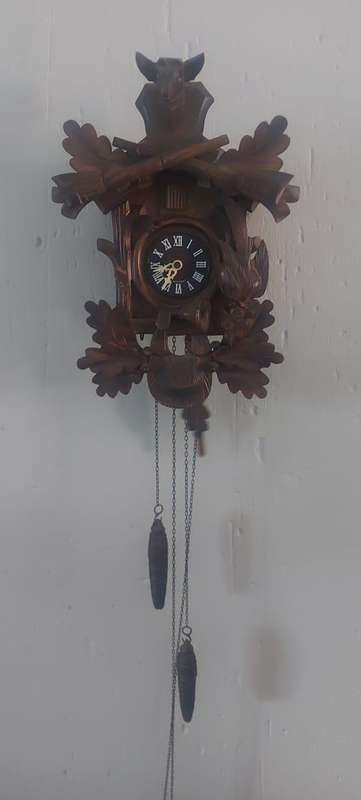 German Black Forest Carved Cuckoo Clock the clock is working but missing one Bird