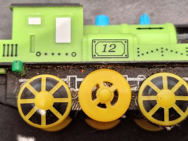 Collection of Hotwheels cars and unmatched train pieces