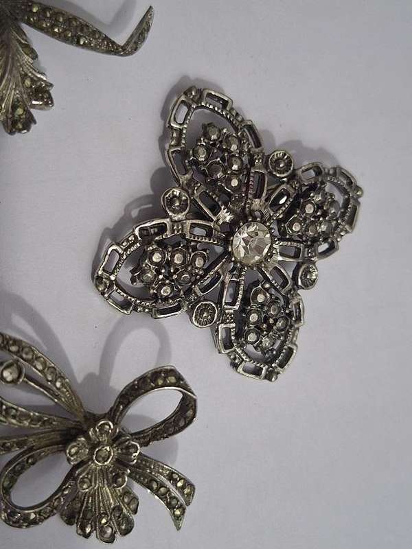 3 x Brooches and 1 pair clip on earrings
