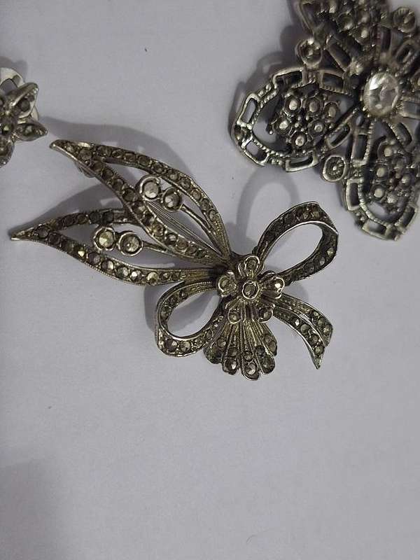 3 x Brooches and 1 pair clip on earrings
