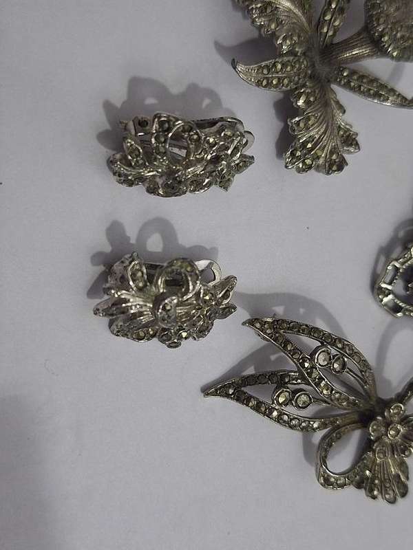 3 x Brooches and 1 pair clip on earrings