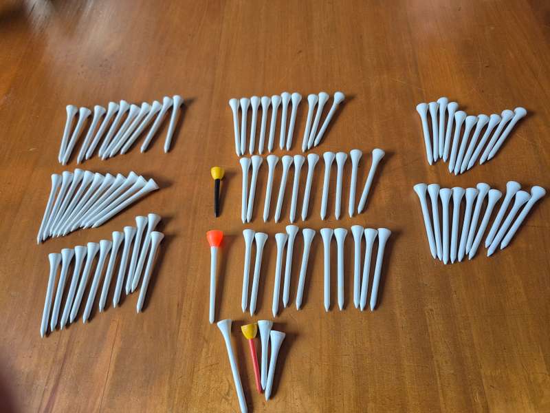 84 wooden golf tees. Look unused.