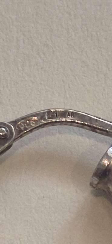 Sterling silver hoop earring 1.1 grams. Marked  .925. 1 AR. Italian mark. Perfect working condition.