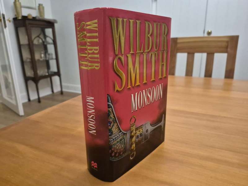 Monsoon. SIGNED AND INSCRIBED BY WILBUR SMITH TO HIS TRAVEL AGENT.