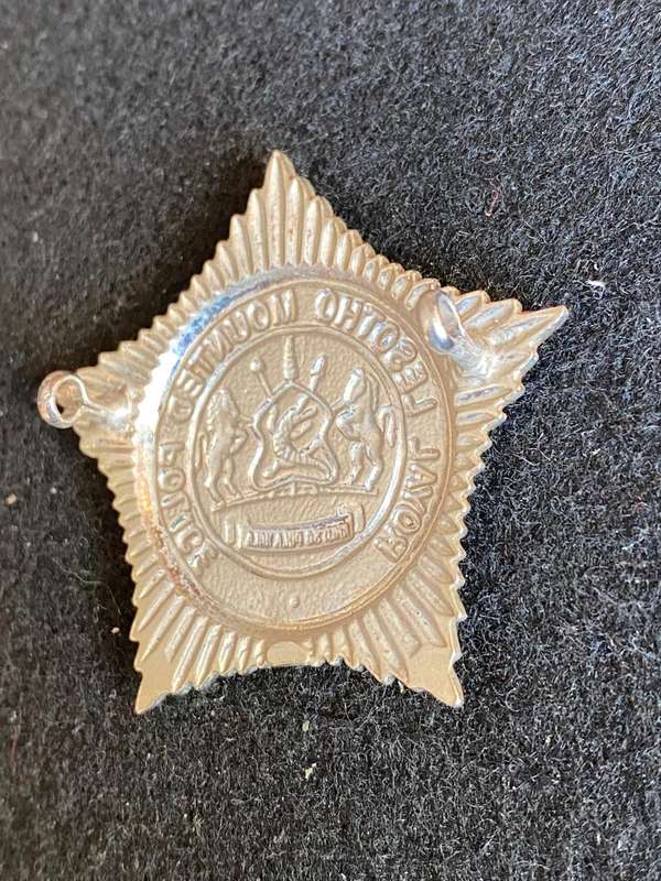 ROYAL LESOTHO MOUNTED POLICE ,WHITE METAL CAP BADGE- 2 LUGS