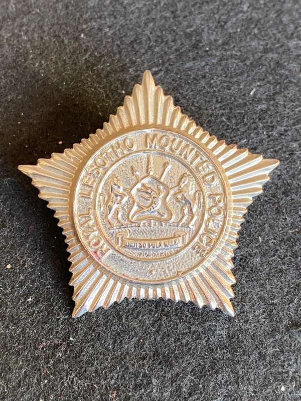 ROYAL LESOTHO MOUNTED POLICE ,WHITE METAL CAP BADGE- 2 LUGS
