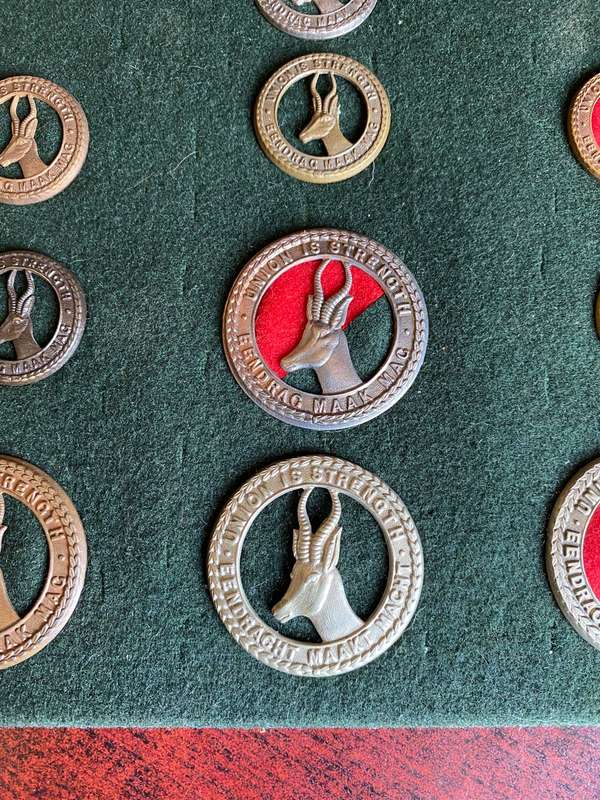 SELECTION OF 18 SA CAP AND COLLAR BADGES- WORN FROM WW1-UNION PERIOD