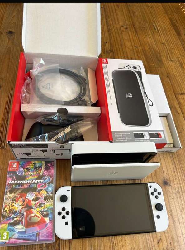 NINTENDO SWITCH-OLED MODEL- IT INCLUDES A 7-INCH VIBRANT OLED SCREEN-A WIDE ADJUSTABLE STAND FOR TAB