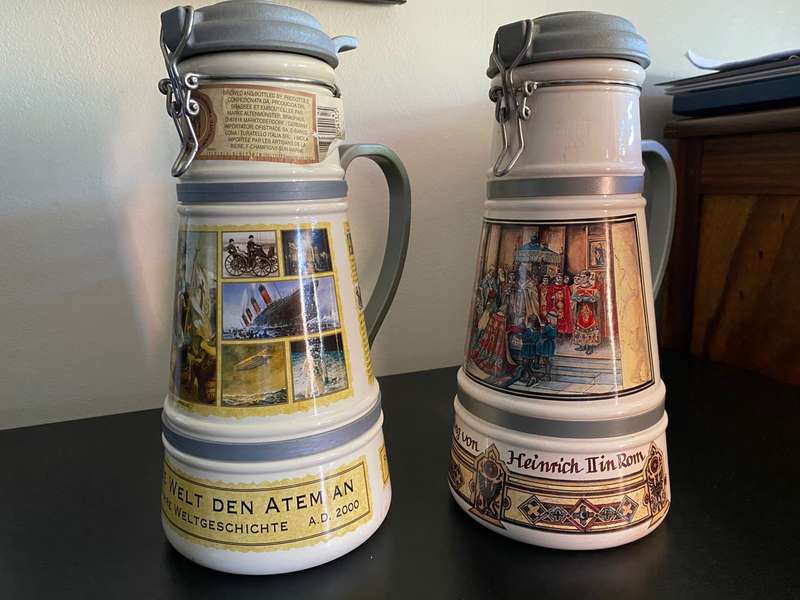 TWO VERY LARGE GERMAN,LIDDED BEER STEINS-PORCELEIN AND STILL SEALED (CONTENTS CANNOT BE GUARANTEED)L
