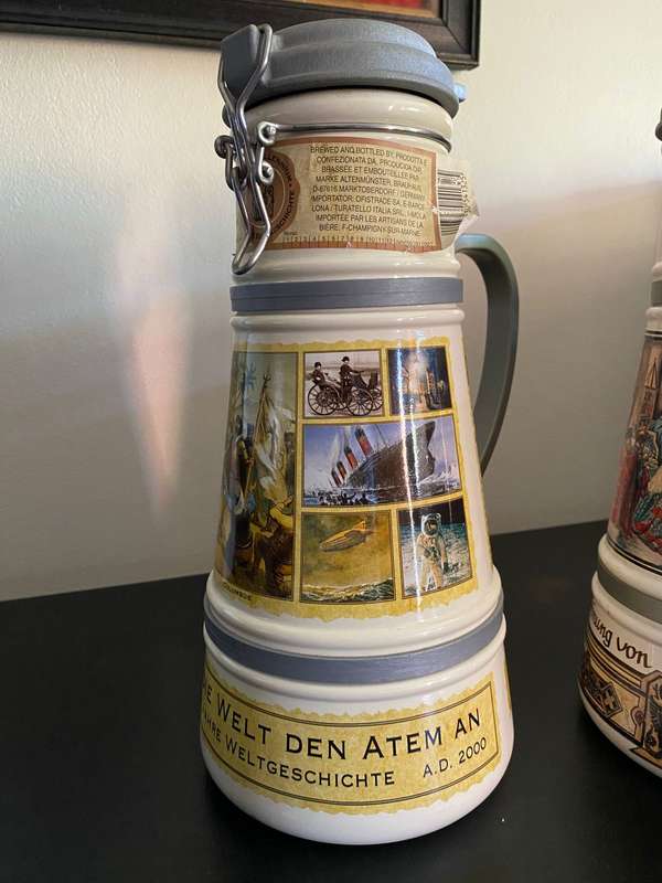 TWO VERY LARGE GERMAN,LIDDED BEER STEINS-PORCELEIN AND STILL SEALED (CONTENTS CANNOT BE GUARANTEED)L