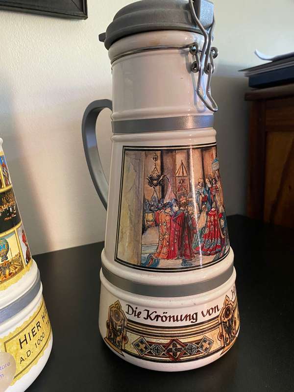 TWO VERY LARGE GERMAN,LIDDED BEER STEINS-PORCELEIN AND STILL SEALED (CONTENTS CANNOT BE GUARANTEED)L