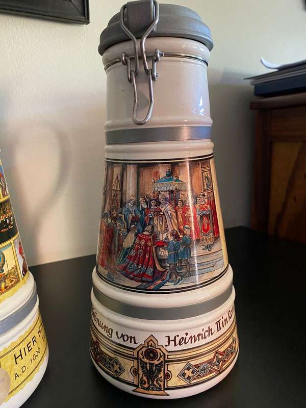 TWO VERY LARGE GERMAN,LIDDED BEER STEINS-PORCELEIN AND STILL SEALED (CONTENTS CANNOT BE GUARANTEED)L