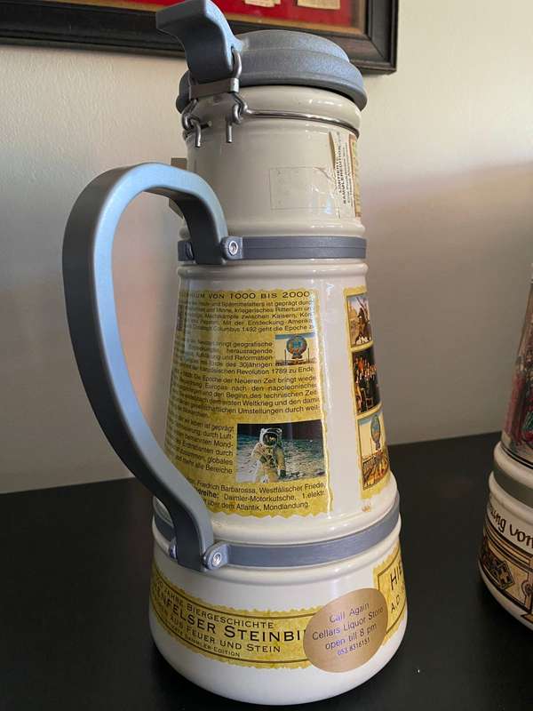 TWO VERY LARGE GERMAN,LIDDED BEER STEINS-PORCELEIN AND STILL SEALED (CONTENTS CANNOT BE GUARANTEED)L