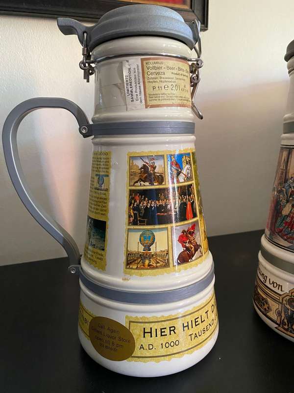 TWO VERY LARGE GERMAN,LIDDED BEER STEINS-PORCELEIN AND STILL SEALED (CONTENTS CANNOT BE GUARANTEED)L
