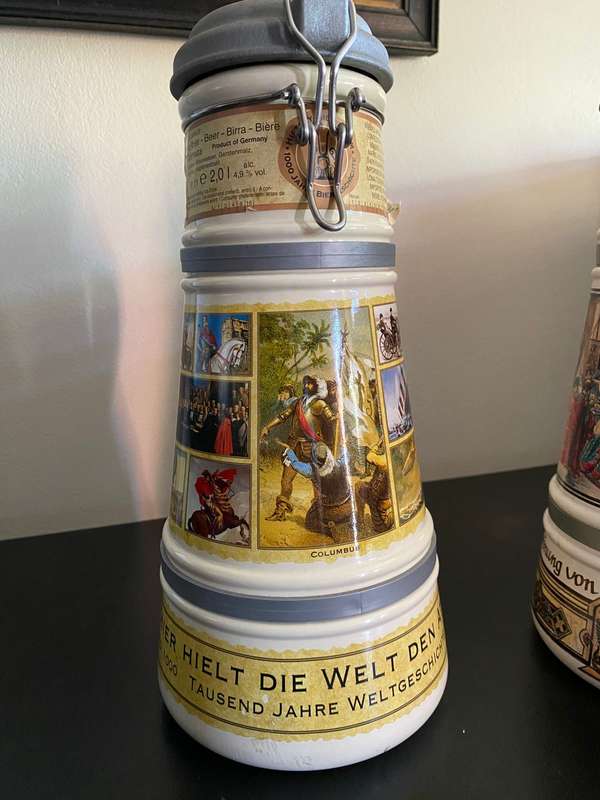 TWO VERY LARGE GERMAN,LIDDED BEER STEINS-PORCELEIN AND STILL SEALED (CONTENTS CANNOT BE GUARANTEED)L