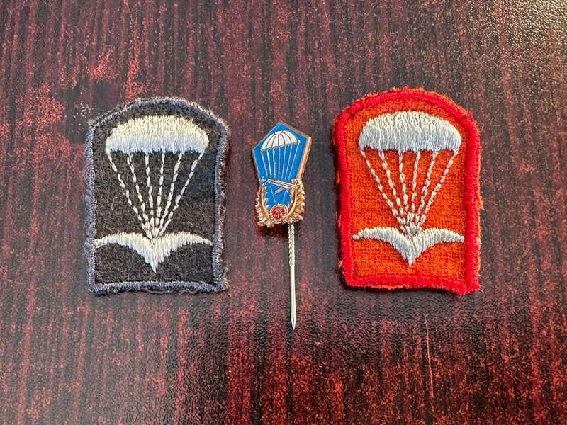 East German para beret badges red (officers) black (Nco's) comes with parachute stick pin. Sold tog