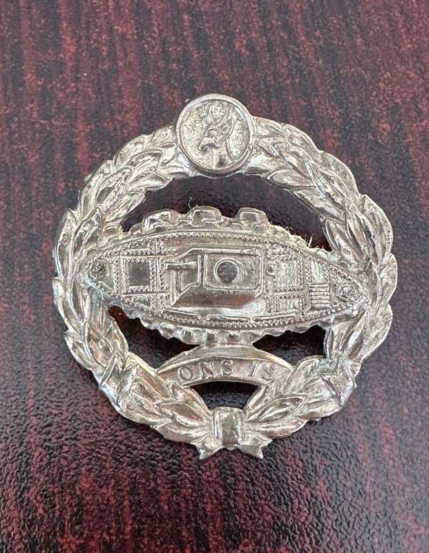 SA tank corps white metal beret badge. Worn Sept 1941- March 1943. 2 Lugs . One repaired