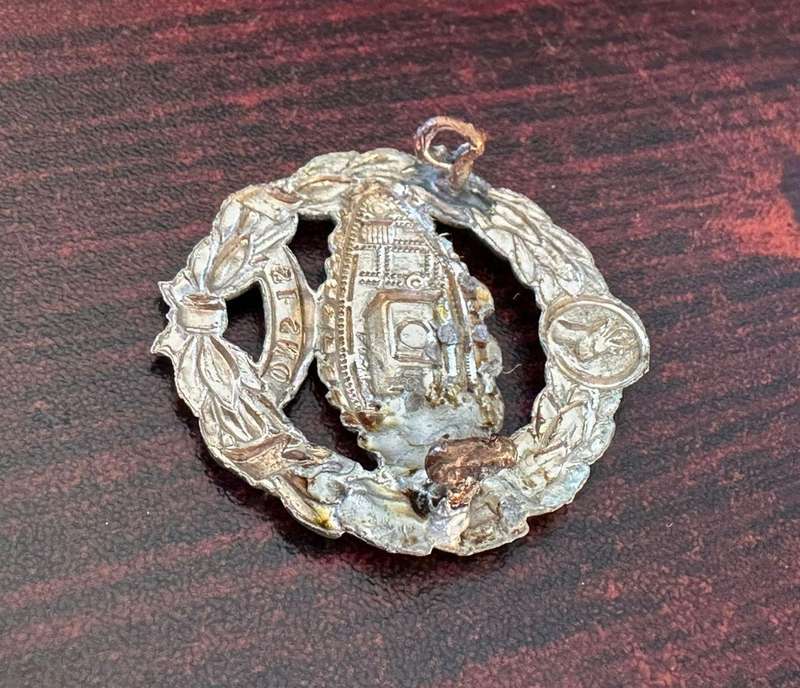 SA tank corps white metal beret badge. Worn Sept 1941- March 1943. 2 Lugs . One repaired