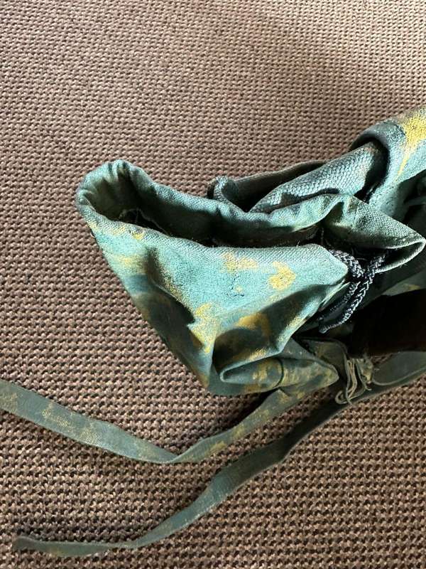 Rhodesian smaller back pack with water bottle side pouch and another open side pouch. measures 47x32