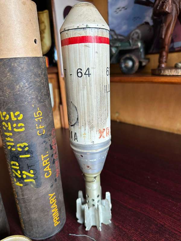 60 MM illuminating bomb type 62 in complete condition ,with range table and holder. Inert