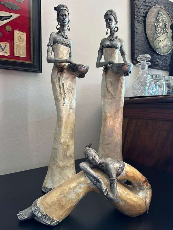 Three decorative composite moulded figurines,decorated with applied mother of pearl. Height of talle