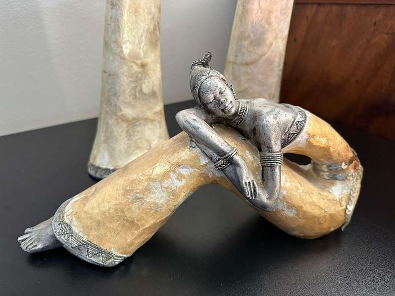 Three decorative composite moulded figurines,decorated with applied mother of pearl. Height of talle