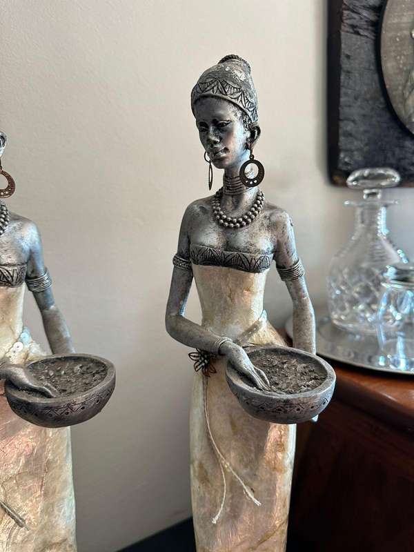 Three decorative composite moulded figurines,decorated with applied mother of pearl. Height of talle
